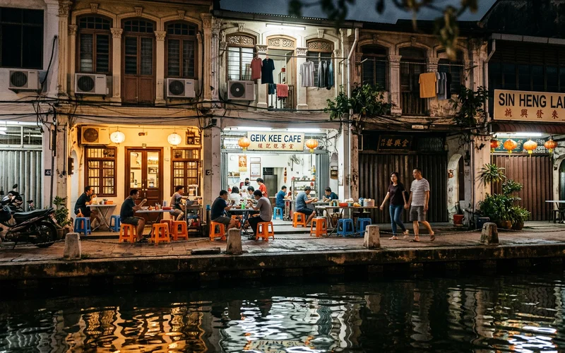 Illuminated Malacca shophouses reflected in the river at night