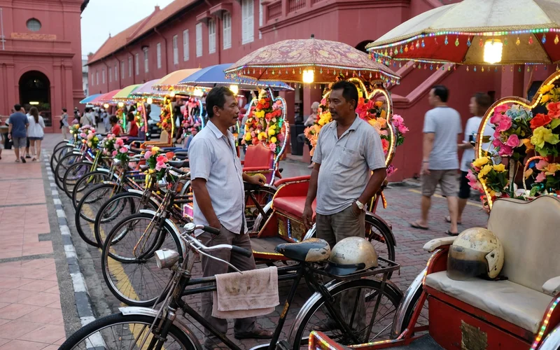 A row of decorated trishaws waiting by the Red Square in Malacca