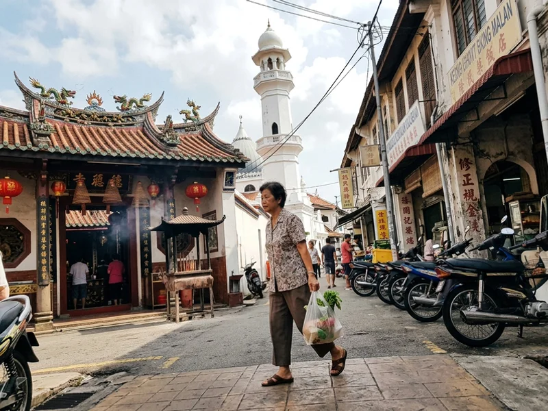 Temple and mosque rooftops along Harmony Street in Malacca