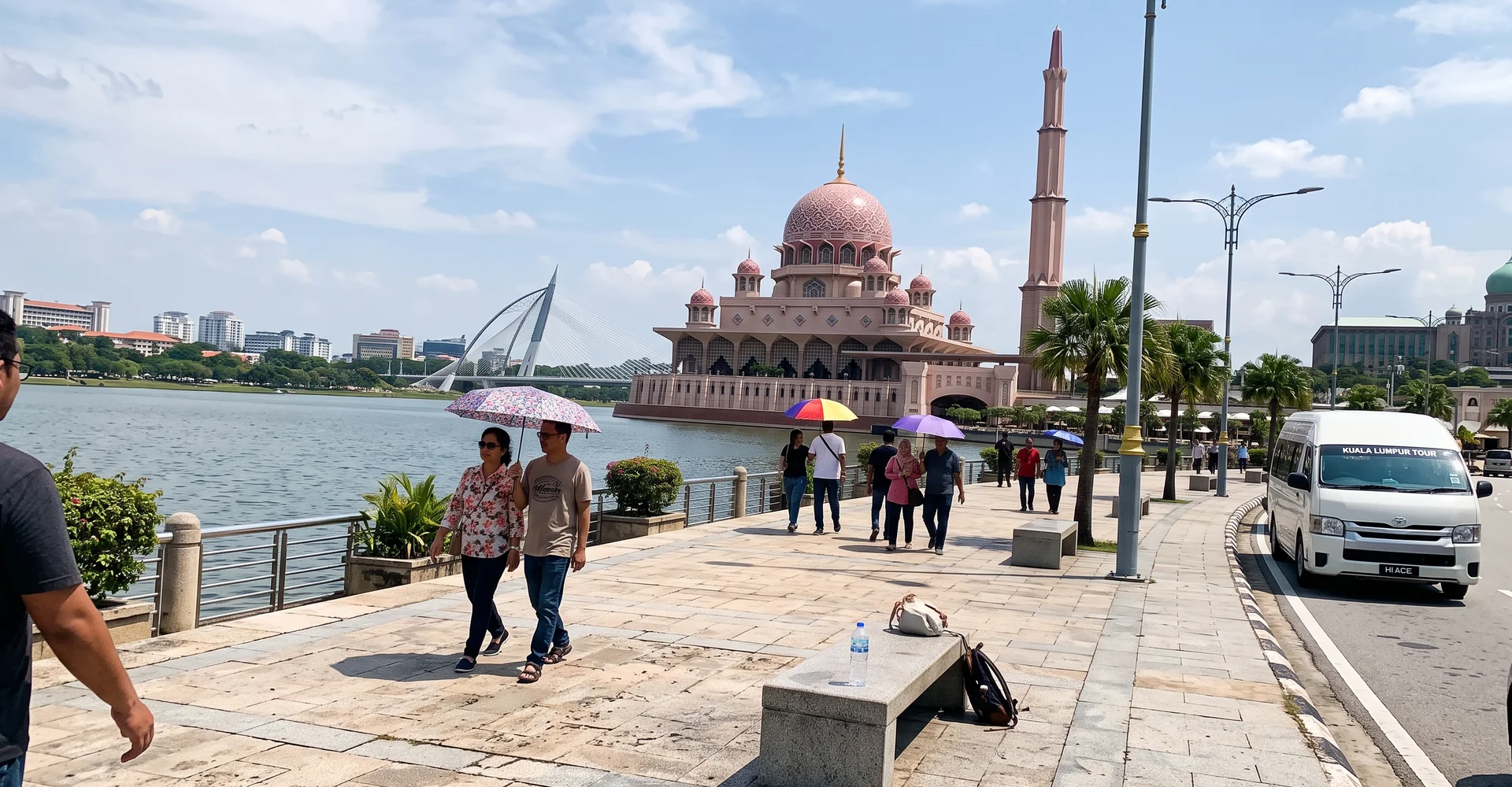 The pink dome of Putra Mosque beside the lake in Putrajaya on a bright afternoon